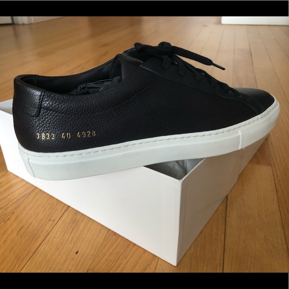 white sneakers with gold numbers